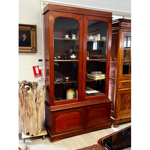 561 - Antique Australian cedar two height library bookcase, large glazed two door top, with adjustable she... 
