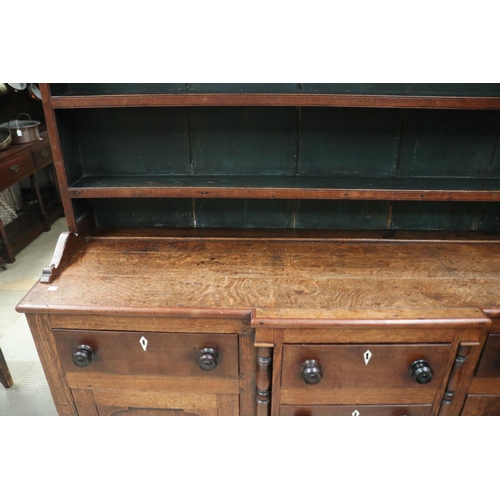 512 - Antique early 19th century English oak two height dresser. Open inlaid shelf top, over a base with c... 