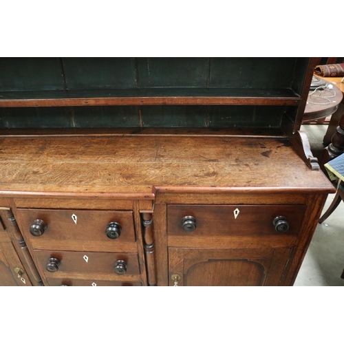 512 - Antique early 19th century English oak two height dresser. Open inlaid shelf top, over a base with c... 