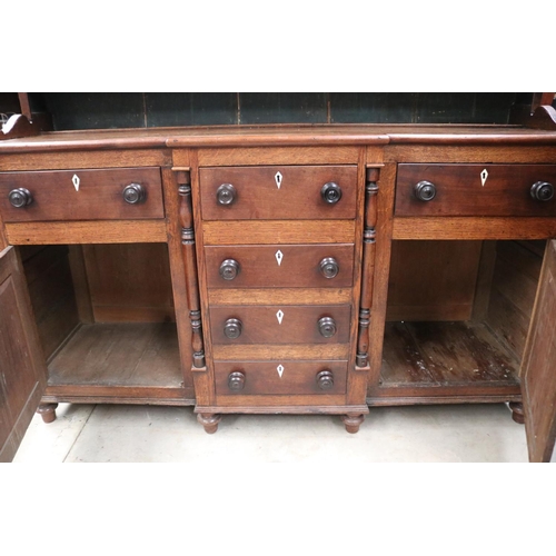 512 - Antique early 19th century English oak two height dresser. Open inlaid shelf top, over a base with c... 