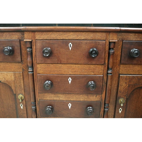 512 - Antique early 19th century English oak two height dresser. Open inlaid shelf top, over a base with c... 