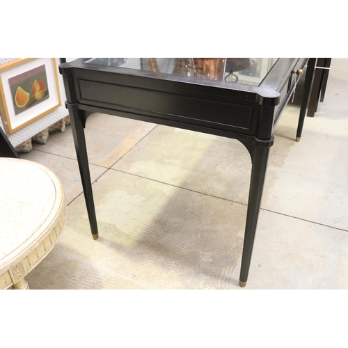 580 - Stylish ebonized single drawer desk, with inset glass top.  tapering legs, brass caps to the tops, a... 