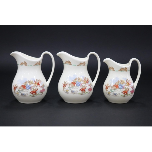 5147 - Royal Doulton, Bunnykins pair of jugs and a smaller example Snow, approx 12.5cm H & smaller (3)