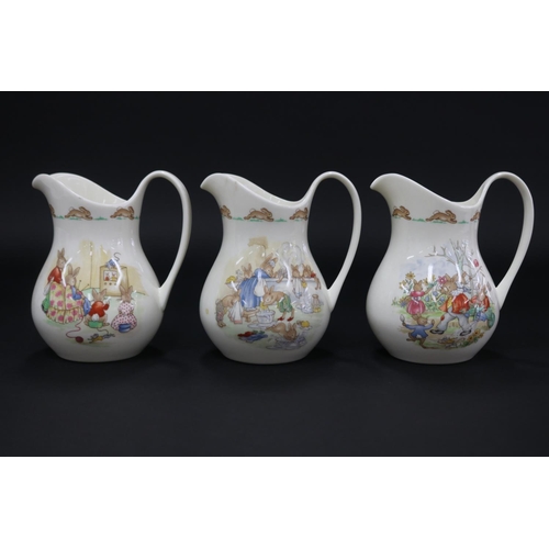 5179 - Royal Doulton, Bunnykins three large jugs, gardening, TV, bath time, approx 15.5cm H each