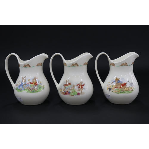 5179 - Royal Doulton, Bunnykins three large jugs, gardening, TV, bath time, approx 15.5cm H each