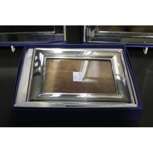 348 - Three boxed as new Whitehill silver plated photograph frames, approx 22cm x 17cm and smaler (3)