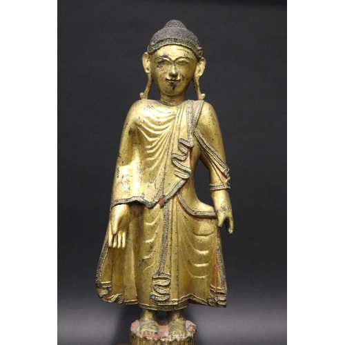 412 - Standing antique gilt wood Thai Buddha, approx 64cm H including stand