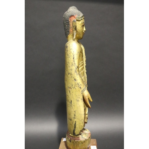 412 - Standing antique gilt wood Thai Buddha, approx 64cm H including stand