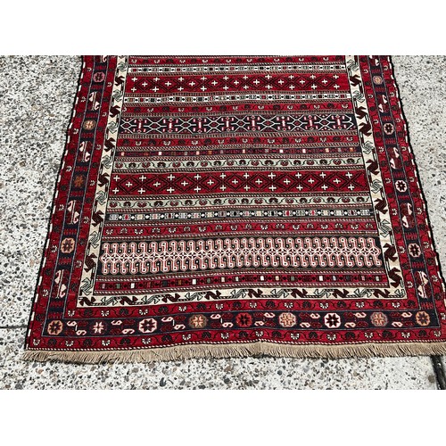 2082 - Red carpet with striped pattern, approx 207cm x 126cm
