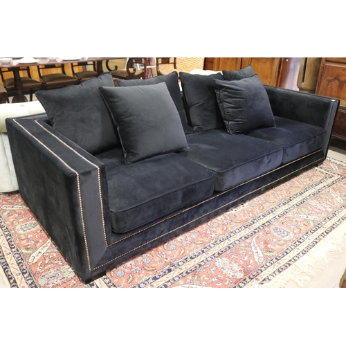 2167 - Modern as new, black velour four seater couch, with loose cushions, double brass studded trim, appro... 