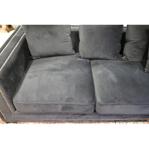 2167 - Modern as new, black velour four seater couch, with loose cushions, double brass studded trim, appro... 