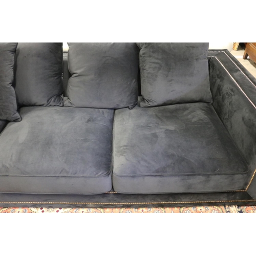2167 - Modern as new, black velour four seater couch, with loose cushions, double brass studded trim, appro... 