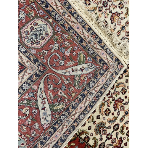 2171 - Large Iranian wool carpet, 20th century, hand knotted wool, ivory field with a herati ground, centra... 