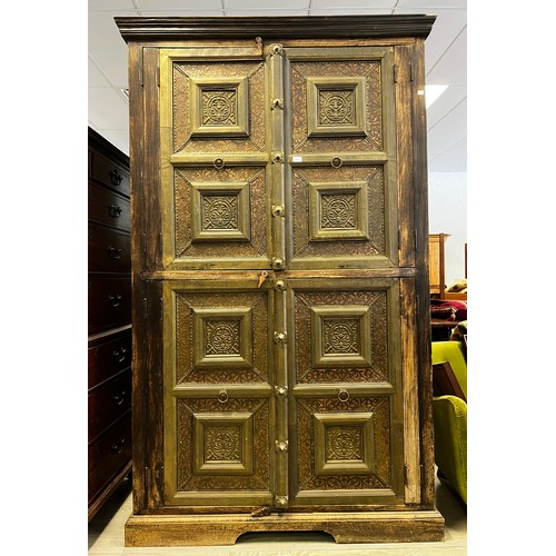 2216 - Large Indian four door cabinet, with applied stepped brass framed panels and applied bosses, approx ... 