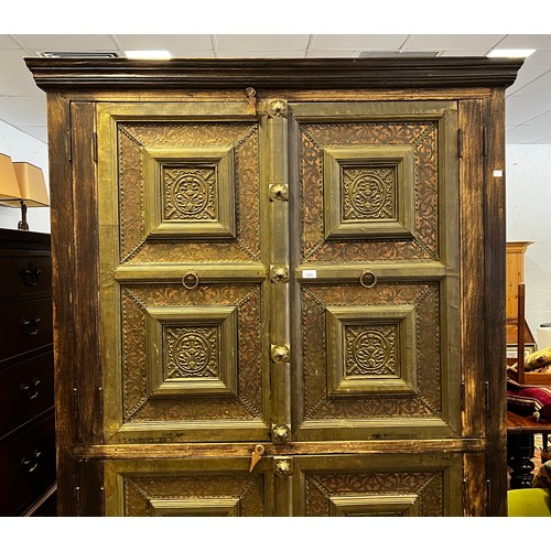 2216 - Large Indian four door cabinet, with applied stepped brass framed panels and applied bosses, approx ... 