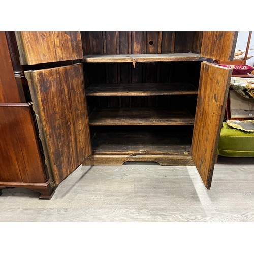 2216 - Large Indian four door cabinet, with applied stepped brass framed panels and applied bosses, approx ... 