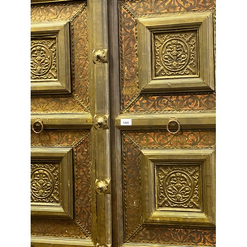 2216 - Large Indian four door cabinet, with applied stepped brass framed panels and applied bosses, approx ... 