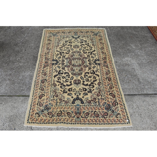 2457 - Hand woven carpet of ivory ground, approx 225cm x 140cm