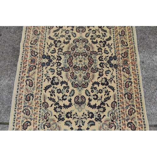 2457 - Hand woven carpet of ivory ground, approx 225cm x 140cm