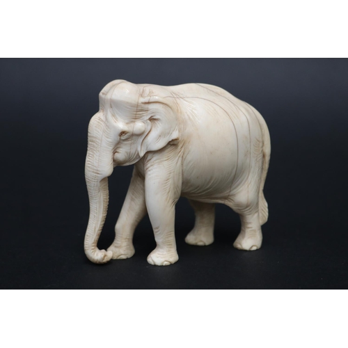 24 - Finely carved ivory figure of an elephant, showing age, approx 7.5cm H x 8cm L