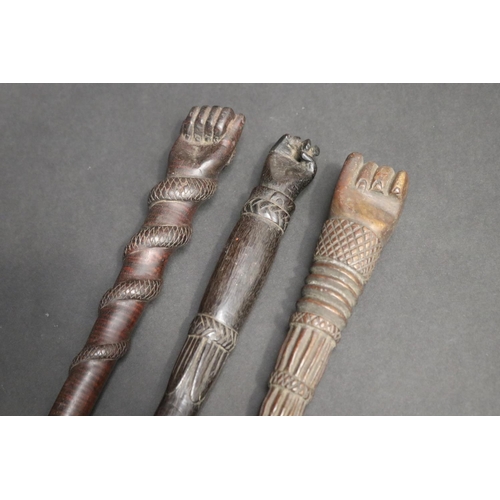 50 - Three antique folk art sailor's carved wood handles, each with clenched fists, approx 51cm L and sho... 