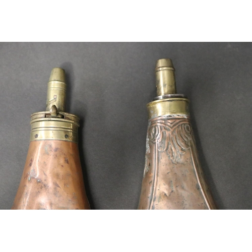 60 - Two antique copper powder flasks, one with embossed decoration, approx 22cm L and shorter (2)