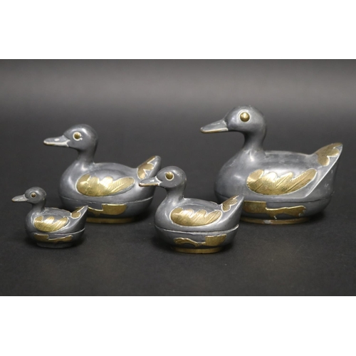 63 - Set of four graduating pewter and brass duck boxes, approx 8cm H x 9.5cm W and smaller (4)