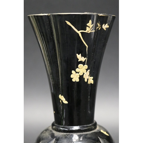 212 - Antique black glass vase with gilt highlight decoration, standing to a dog of fo motif base, approx ... 