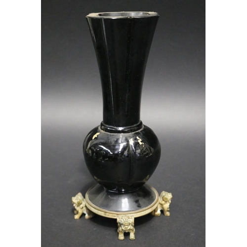 212 - Antique black glass vase with gilt highlight decoration, standing to a dog of fo motif base, approx ... 