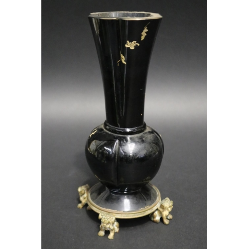 212 - Antique black glass vase with gilt highlight decoration, standing to a dog of fo motif base, approx ... 