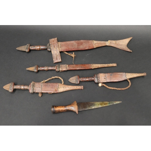 72 - Selection of 20th century North African steel and leather daggers, approx 48cm L and shorter (5)