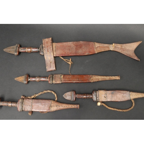 72 - Selection of 20th century North African steel and leather daggers, approx 48cm L and shorter (5)