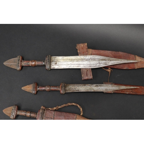 72 - Selection of 20th century North African steel and leather daggers, approx 48cm L and shorter (5)