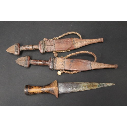 72 - Selection of 20th century North African steel and leather daggers, approx 48cm L and shorter (5)