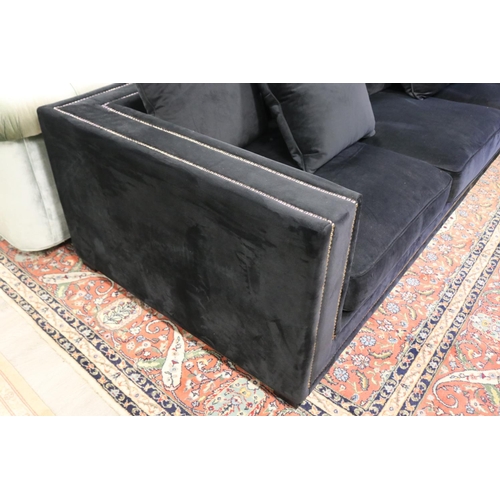 288 - Modern as new, black velour four seater couch, with loose cushions, double brass studded trim, appro... 