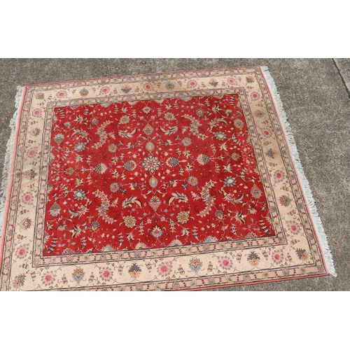 384 - Fine quality Iranian rug - wool and silk hand knotted carpet, central red field with ivory border, a... 