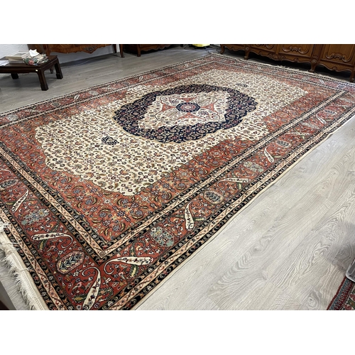 404 - Large Iranian wool carpet, 20th century, hand knotted wool, ivory field with a herati ground, centra... 