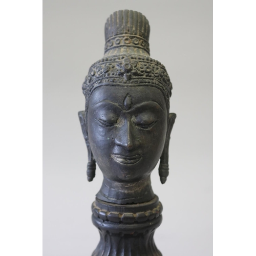 295 - South East Asian bronze Buddha head on carved turned wood stand, approx 32cm H including stand