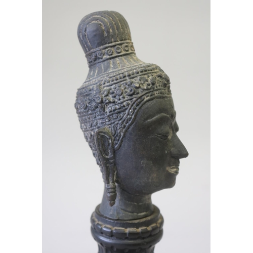 295 - South East Asian bronze Buddha head on carved turned wood stand, approx 32cm H including stand