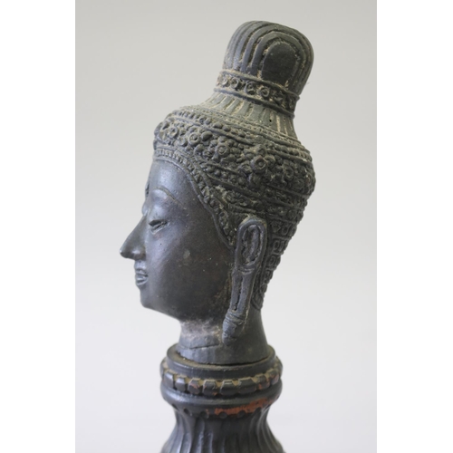 295 - South East Asian bronze Buddha head on carved turned wood stand, approx 32cm H including stand