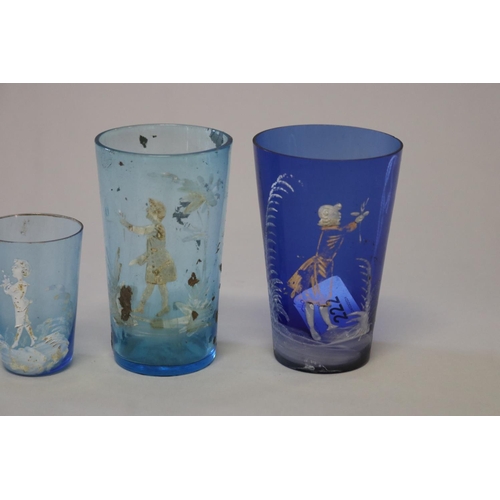 222 - Four antique Mary Gregory blue glass beakers (4)