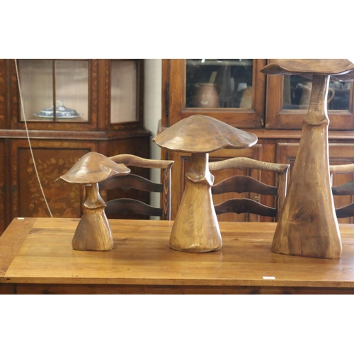 307 - Set of four large decorative carved walnut toadstools, of graduating size, approx 97cm H and shorter... 