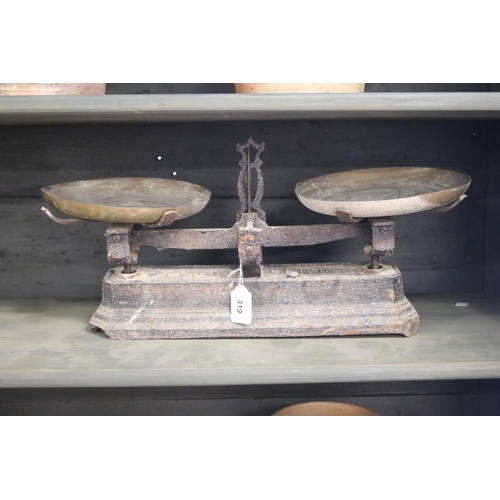 319 - Antique French set of iron based scales with brass pans, 5 kilo, approx 24cm H x 51cm W