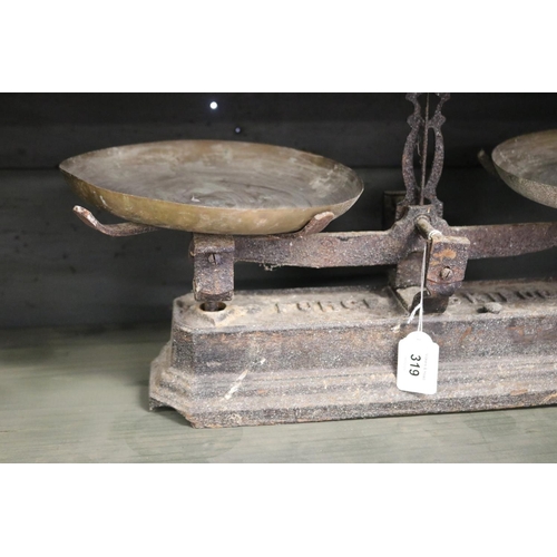 319 - Antique French set of iron based scales with brass pans, 5 kilo, approx 24cm H x 51cm W