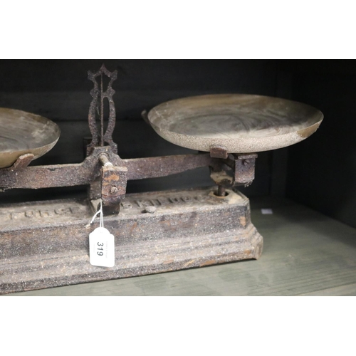 319 - Antique French set of iron based scales with brass pans, 5 kilo, approx 24cm H x 51cm W