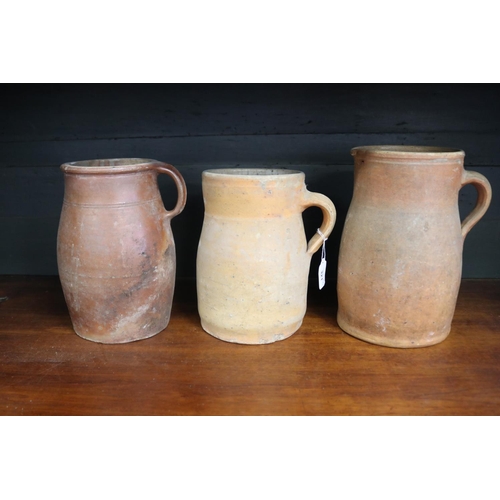 321 - Three antique French stoneware jugs, approx 27cm H and shorter (3)