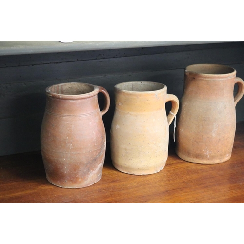 321 - Three antique French stoneware jugs, approx 27cm H and shorter (3)