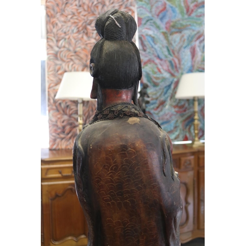 258 - Large red lacquered wood figure of Guanyin, some losses and flaking, approx 93cm H
