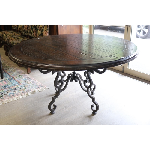 326 - Antique style circular wooden topped dining table with wrought iron base, approx 76cm H x 142cm Dia