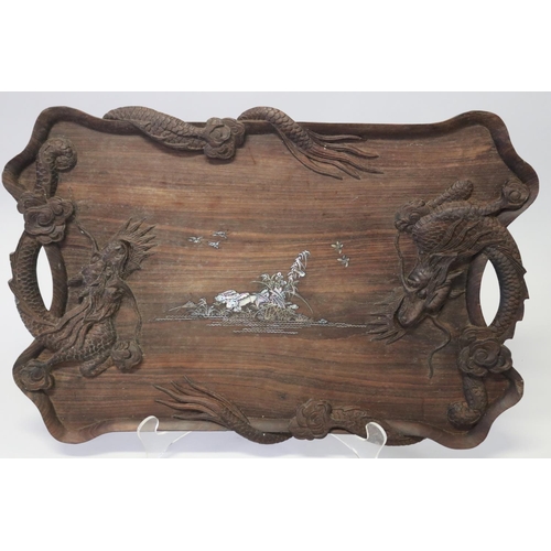 386 - Oriental hardwood twin handled tray decorated with dragon in relief and mother of pearl inlaid cente... 